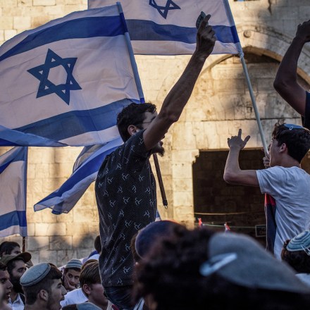 15 June 2021, Israel, Jerusalem: People gather at the Damascus Gate of the Old City of Jerusalem with flags of Israel during the controversial Flag March, organized by Israeli right-wing nationalists. Photo: Ilia Yefimovich/dpa (Photo by Ilia Yefimovich/picture alliance via Getty Images)