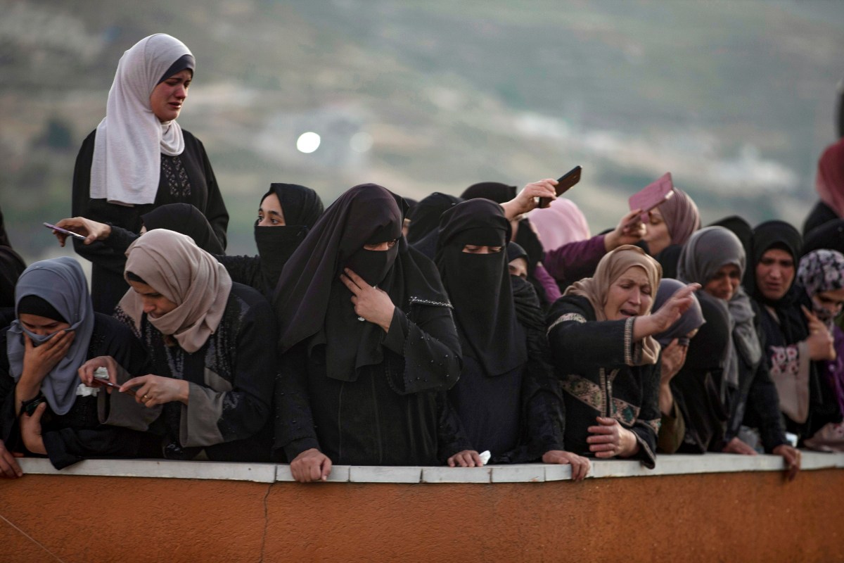 Palestinian women mourn for Nidal Safadi, who was killed in clashes with Israeli forces, during his funeral in the West Bank village of Urif, near Nablus, Friday, May 14, 2021.(AP Photo/Majdi Mohammed)