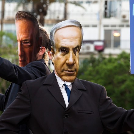 TEL AVIV, ISRAEL - JUNE 23: Demonstrators wear masks of Israeli Prime Minister Benjamin Netanyahu, and Defense Minister Benny Gantz as they protest against the Israeli goverment's plan to annex parts of the West Bank on June 23, 2020 in Tel Aviv, Israel. Defense Minister Benny Gantz, who formed a coalition government with Prime Minister Benjamin Netanyahu to break an electoral stalemate, has signaled he will not oppose the prime minister's unilateral move.  (Photo by Amir Levy/Getty Images)