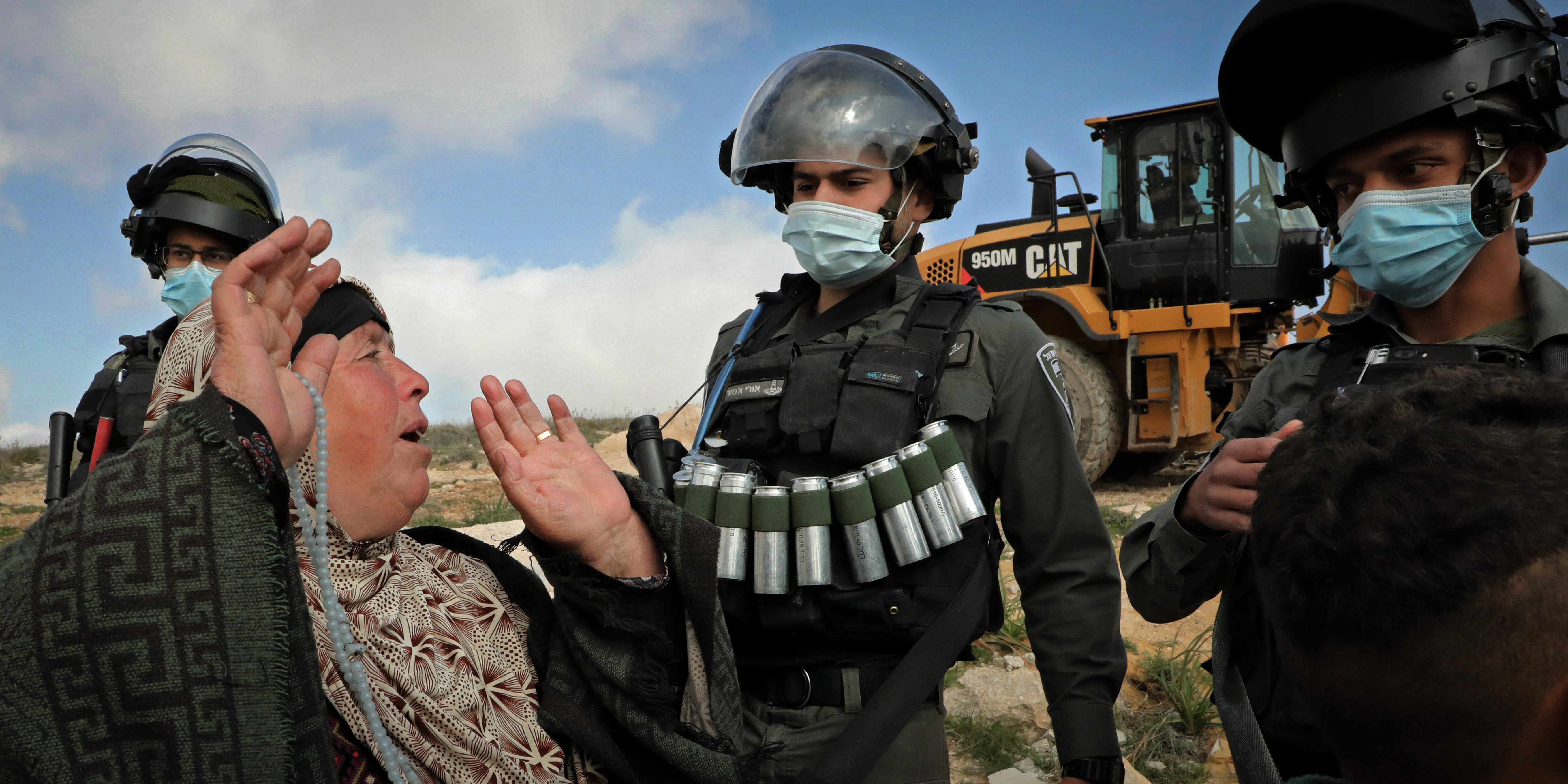 TOPSHOT - Palestinians react as Israeli authorities prepare to demolish a house located within the area C (where Israel retains control, including over planning and construction) in a village south of Yatta in the southern area of the West Bank town of Hebron, on March 2, 2021. (Photo by HAZEM BADER / AFP) (Photo by HAZEM BADER/AFP via Getty Images)