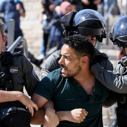 JERUSALEM - MAY 18: Israeli forces take a Palestinian into custody as Palestinians gathered in front of Jerusalem's Damascus Gate to protest against Israeli attacks on Gaza Strip, in East Jerusalem on May 18, 2021. Israeli forces assaulted and arrested Palestinians. (Photo by Mostafa Alkharouf/Anadolu Agency via Getty Images)