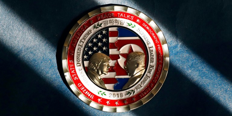 A commemorative coin released by the White House for a potential "peace summit," featuring the names and silhouettes of U.S. President Donald Trump and North Korean leader Kim Jung Un, is arranged photograph taken in Washington, D.C., U.S., on Thursday, May 24, 2018. Trump canceled his planned summit with Kim Jong Un that had been scheduled for June 12 in Singapore, citing "tremendous anger and open hostility" in recent statements from Pyongyang. Photographer: Yuri Gripas/Bloomberg via Getty Images