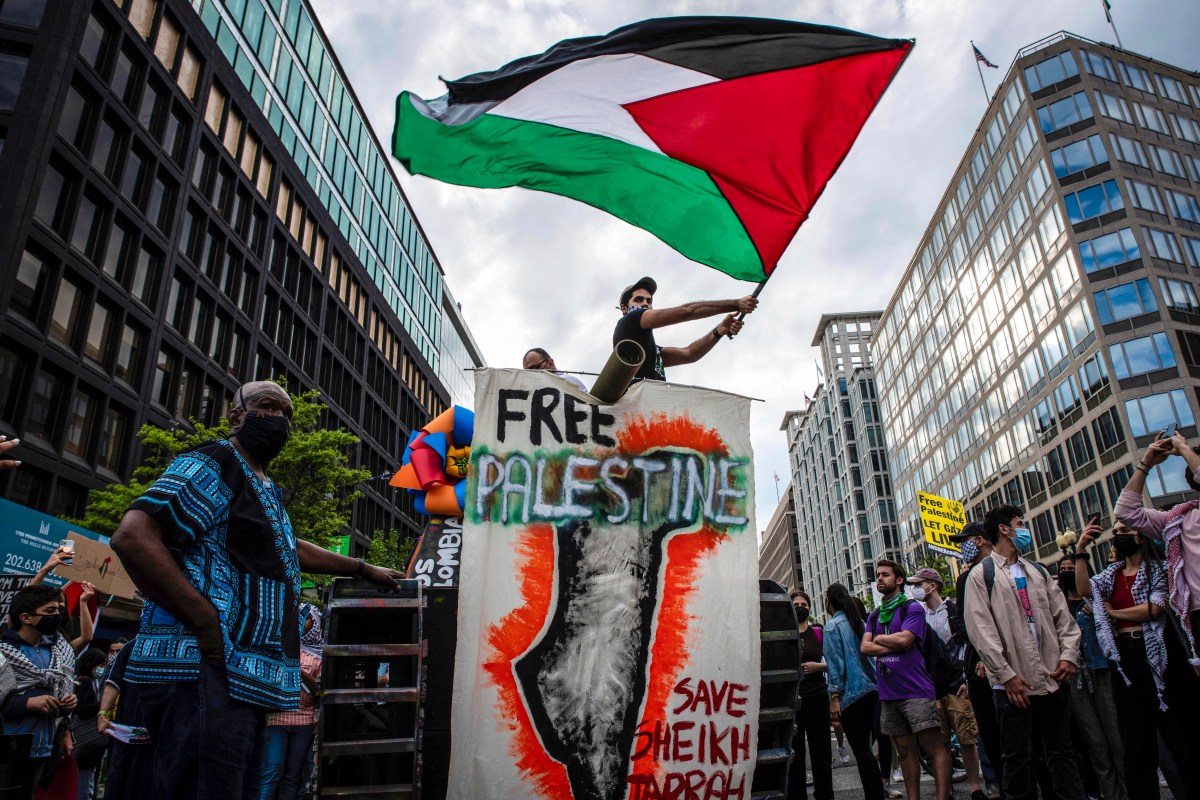 A pro-Palestinian demonstrator waves a Palestinian flag atop a mock wooden tank near the White House in Washington, D.C. on May 11, 2021. Palestinians and their supporters demanded President Joe Biden and Secretary of State Antony Blinken stop Israel's eviction of Palestinian families from the Sheikh Jarrah neighborhood in east Jerusalem. (Photo by Alejandro Alvarez/Sipa USA)(Sipa via AP Images)