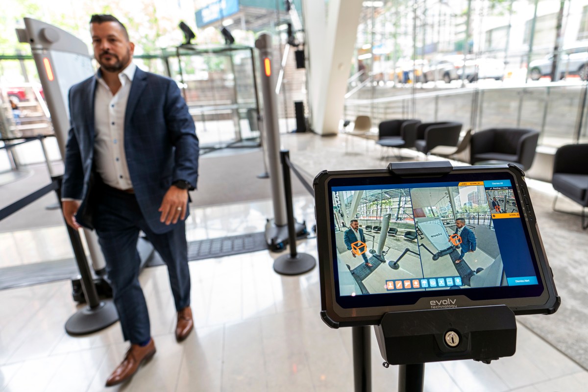 An employee for Evolv Technology, demonstrates the Evolv Express weapons detection system, which is showing red lights to flag a weapon he is wearing on his hip, Wednesday, May 25, 2022, in New York. (AP Photo/Mary Altaffer)