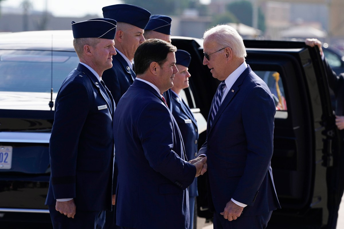 President Joe Biden greets Arizona Gov. Doug Ducey after arriving on Air Force One, Tuesday, Dec. 6, 2022, at Luke Air Force Base in Maricopa County, Ariz.