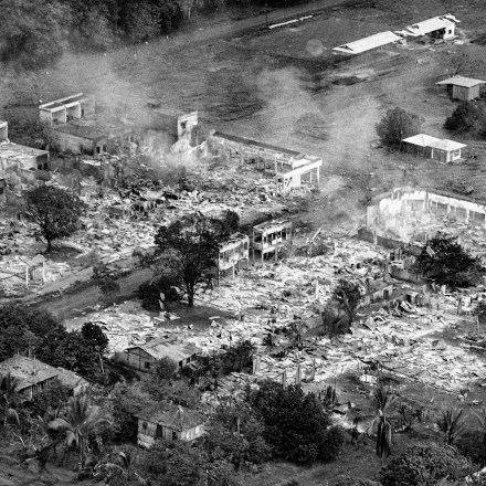 A section of the rubber plantation town of Snoul, Cambodia, smolders in early May 1970, after nearly 90 percent of the town was destroyed in air strikes and heavy fighting between U.S. forces and North Vietnamese troops. By May 6, the U.S. 11th Armored Cavalry Regiment occupied the town. (AP Photo/Henri Huet)