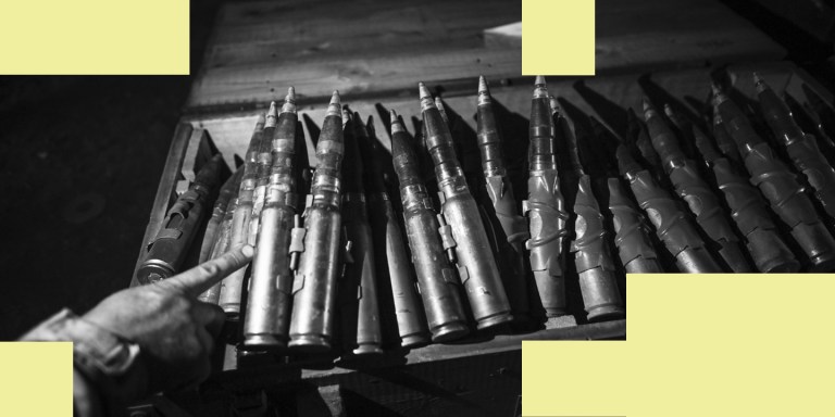 A Ukrainian servicemember points towards 30mm incendiary ammunition inside a storage warehouse, in the Donetsk Region of Ukraine on May 22, 2023. Ukrainian military mechanics and armored vehicle crew members of the 214th Separate Special Battalion conduct field tests and repair operations on damaged and captured vehicles following the battalion's combat missions in city of Bakhmut. (Photo by Justin Yau/ Sipa USA)(Sipa via AP Images)