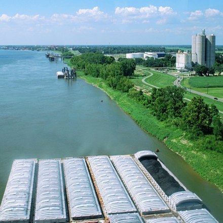 Barges carry coal along the Mississippi River, on the banks of Ascension Parish. This area, along the Mississippi between Baton Rouge and New Orleans, is widely known as "cancer alley" as it is so burdened with polluting industry.