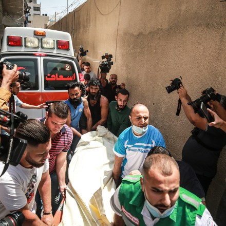 GAZA CITY, GAZA - MAY 11: Palestinians evacuate a building targeted by Israeli warplanes conducting airstrikes in various parts of Gaza Strip, in Gaza City, Gaza on May 11, 2021. Israeli fighters bomb apartment in western Gaza City, kill 3 civilians, several others. (Photo by Mustafa Hassona/Anadolu Agency via Getty Images)