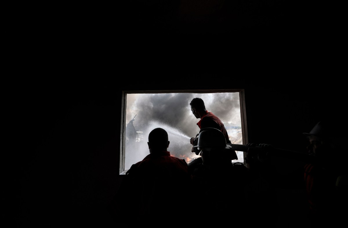 Palestinian firefighters douse a huge fire at the Foamco mattress factory east of Jabalia in the northern Gaza Strip, on May 17, 2021. (Photo by MAHMUD HAMS / AFP) (Photo by MAHMUD HAMS/AFP via Getty Images)