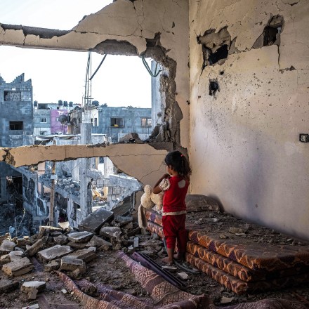 BEIT HANOUN, GAZA - MAY 24:  A Palestinian girl stands amid the rubble of her destroyed home on May 24, 2021 in Beit Hanoun, Gaza. Gaza residents continue clean up operations as they return to damaged and destroyed homes as the ceasefire between Israel and Hamas appeared to be holding into a fourth day. The ceasefire brings to an end 11 days of fighting which left dead more than 250 Palestinians - many of them women and children - and 13 Israelis. The conflict began on May 10 after rising tensions in East Jerusalem and clashes at the Al Aqsa Mosque compound. (Photo by Fatima Shbair/Getty Images)