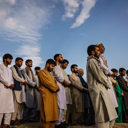 KABUL, AFGHANISTAN -- AUGUST 30, 2021: Islamic prayers are recited for the dead before they could be laid into the ground to be buried, as around 200 people attend a mass funeral for the 10 people the family said to have been killed in a U.S. drone strike, in Kabul, Afghanistan, Monday, Aug. 30, 2021. (MARCUS YAM / LOS ANGELES TIMES)