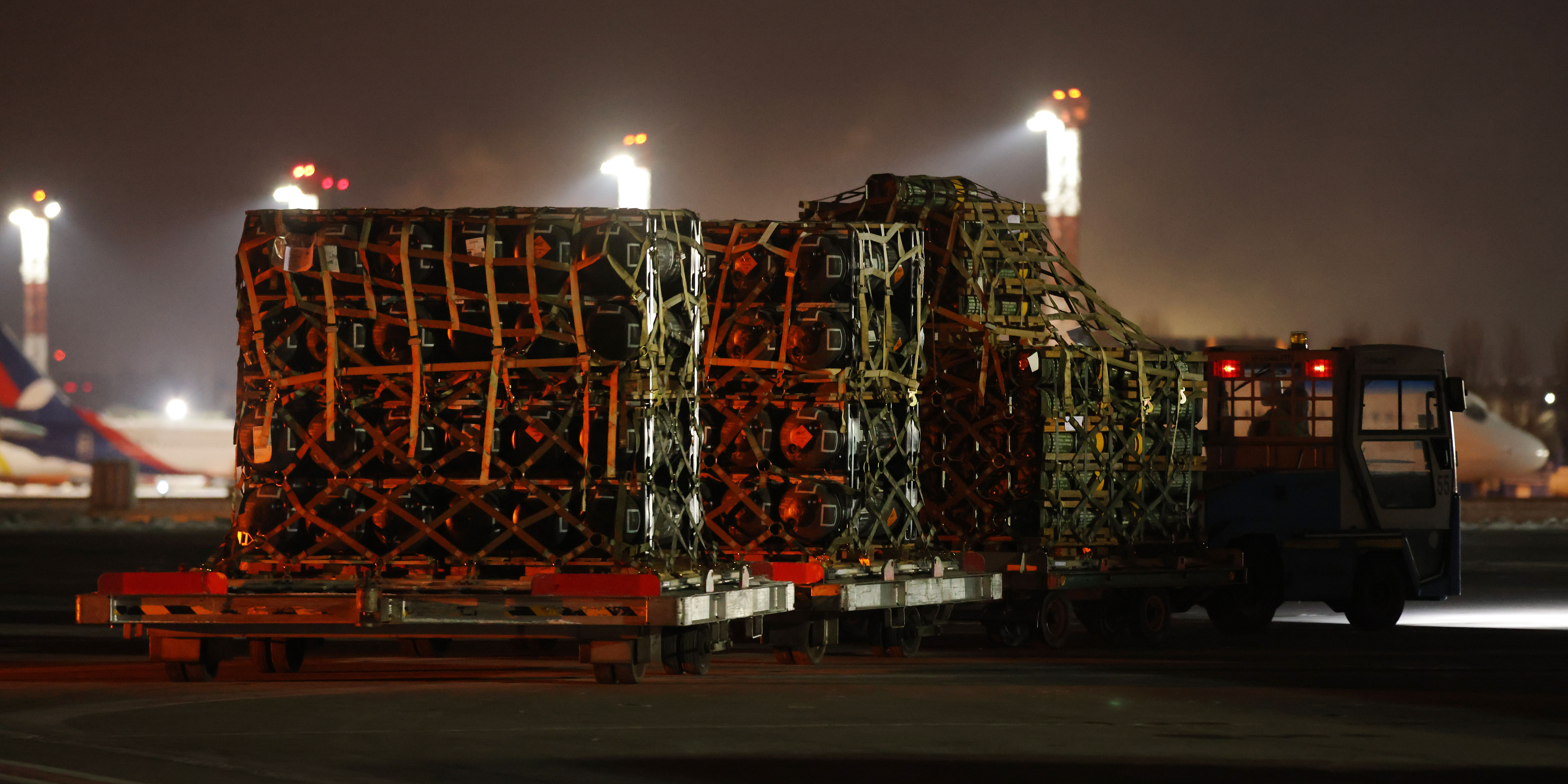 BORYSPIL, UKRAINE - JANUARY 25: An airport vehicle pulls a portion of a shipment of weapons that include Javelin anti-tank missiles and other military hardware delivered on a National Airlines plane by the United States military at Boryspil Airport near Kyiv on January 25, 2022 in Boryspil, Ukraine. The shipment comes as tensions between the NATO military alliance and Russia are intensifying due to Russia's move of tens of thousands of troops as well as heavy weapons to the Ukrainian border, causing international fears of a possible Russian invasion of Ukraine. The U.S., Great Britain and other NATO countries have sent arms in recent days to Ukraine in a bid to deter an invasion. (Photo by Sean Gallup/Getty Images)