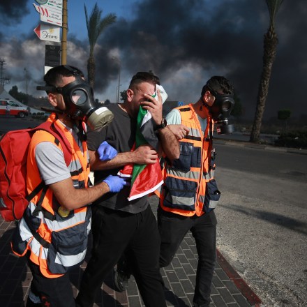 RAMALLAH, WEST BANK - OCTOBER 13: A Palestinian man receives medical assistance after he has been affected from the tear gas as Palestinians clash with Israeli forces in Beit El district of Ramallah, West Bank on October 13, 2023. (Photo by Issam Rimawi/Anadolu via Getty Images)